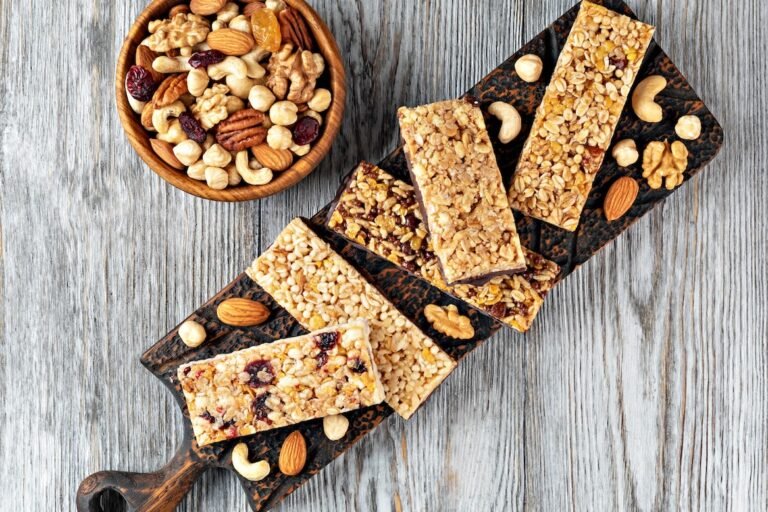 Granola bars with nuts and dried fruits on wooden background