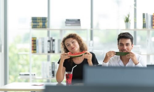 Two office workers searching for tourist attractions, booking tickets, and prepar suitcase to travel in the summer